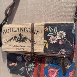 Myra canvas bag with leather strap. NWT . Has Zip closure and Buckle, pockets